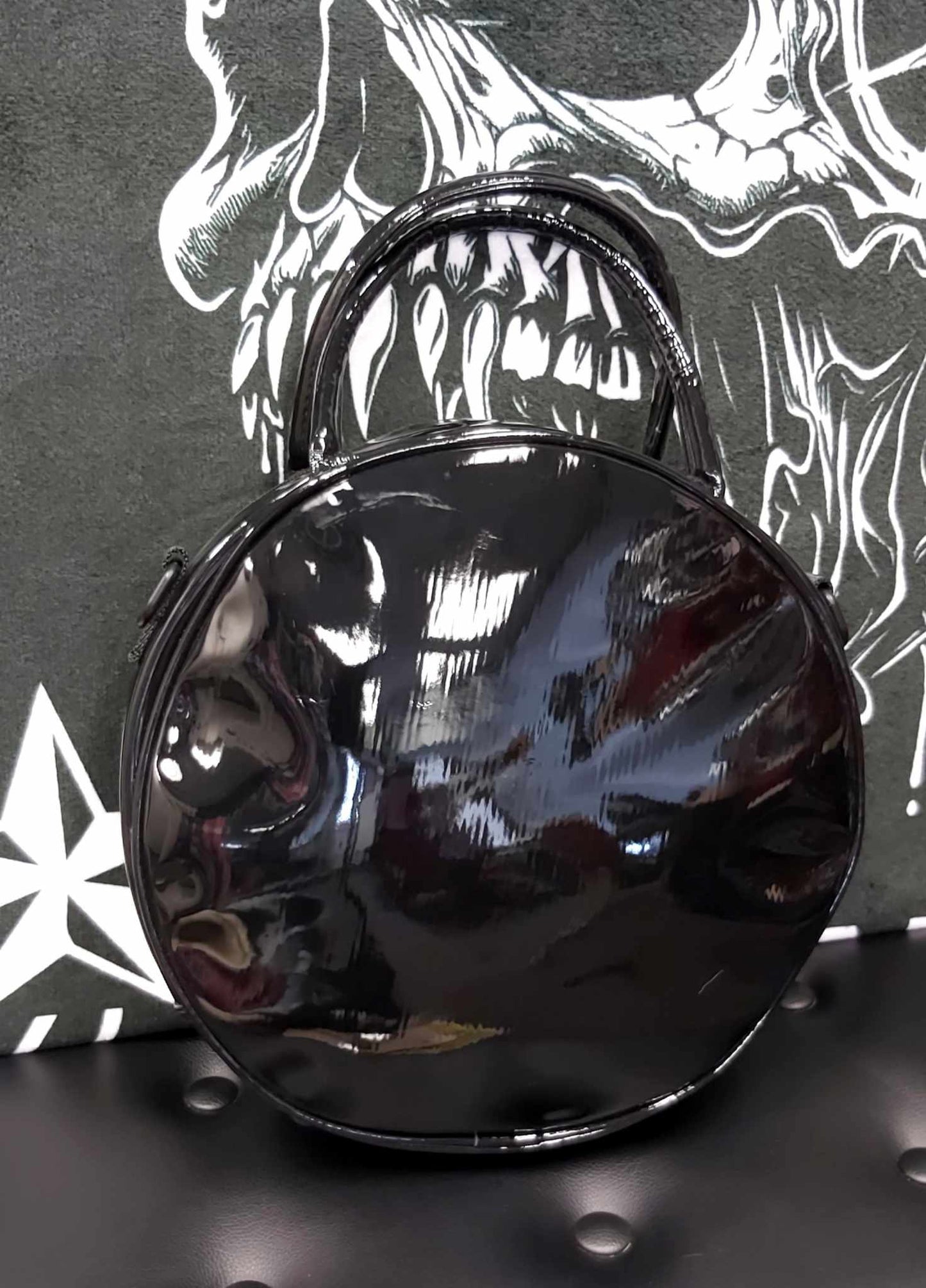 Quarter moon face on round purse