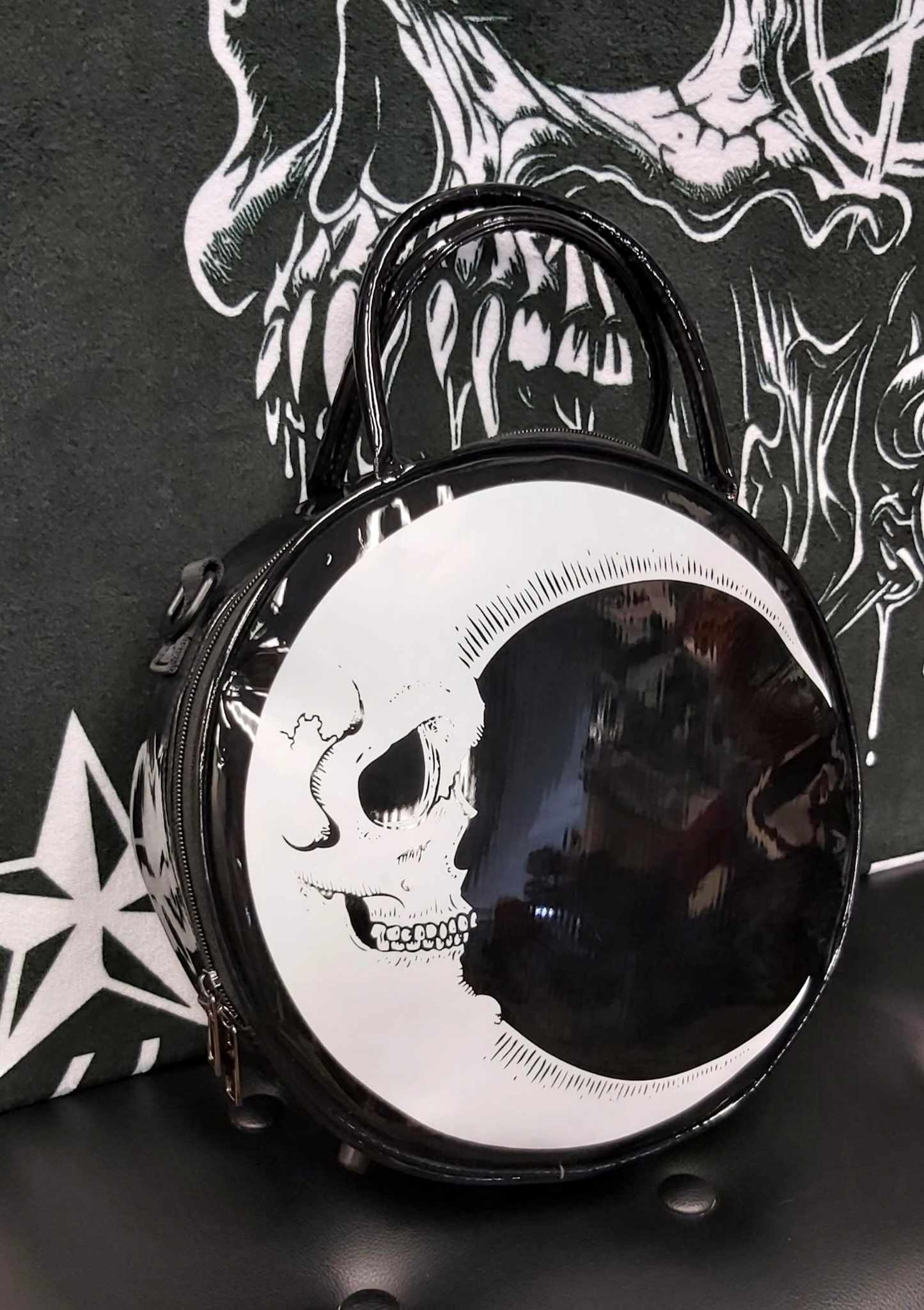 Quarter moon face on round purse